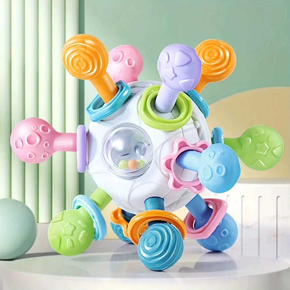 Buntes Hundespielzeug mit vielen drehbaren Armen und Noppen vor hellgrünem Hintergrund.